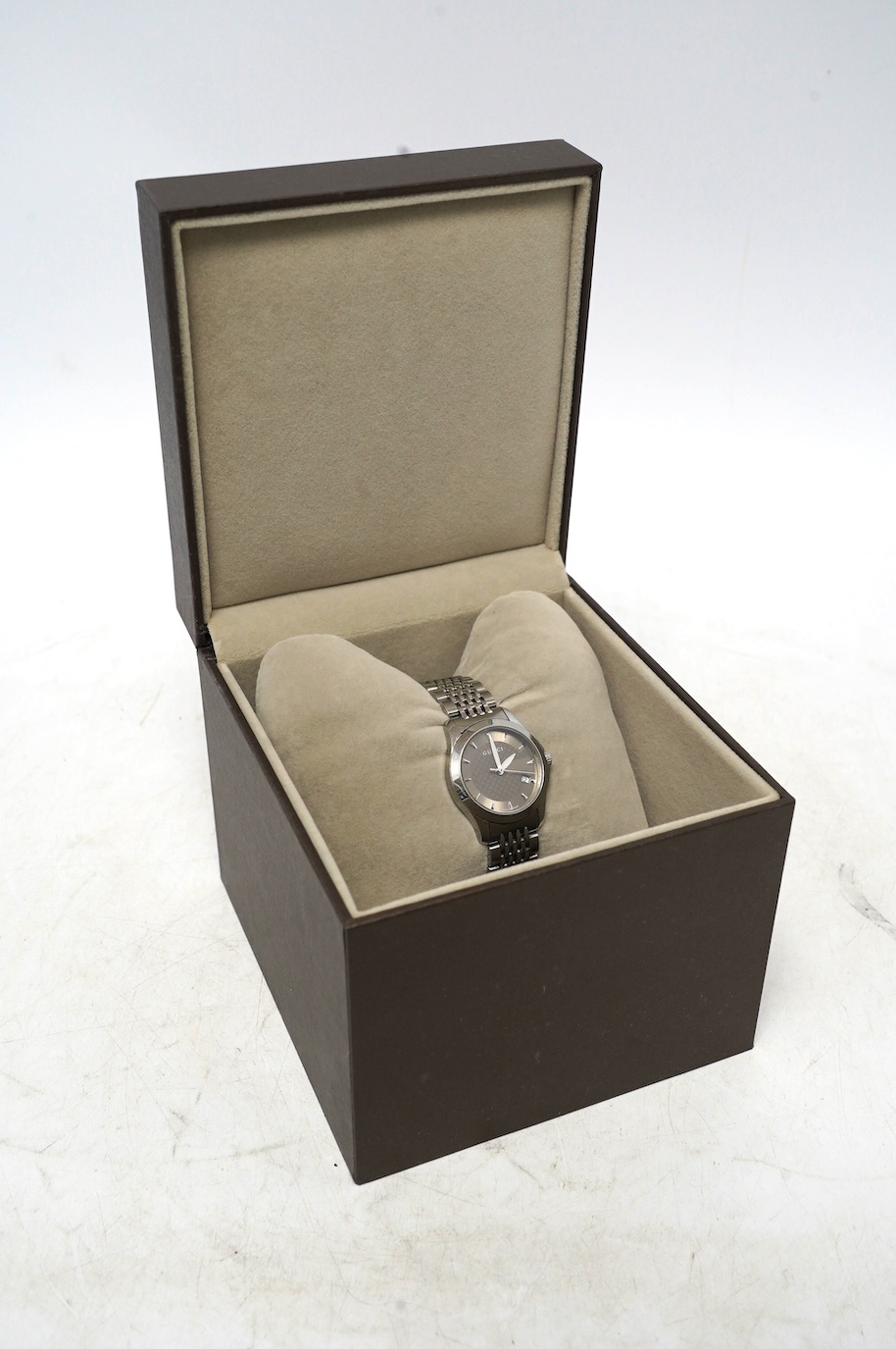 A lady's modern stainless Gucci quartz wrist watch, with date aperture, box and booklet. Condition - fair